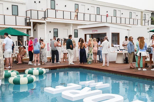 Guests gathered around the waterfront pool deck at Offshore Montauk, a boutique hotel and resort in Montauk, New York.